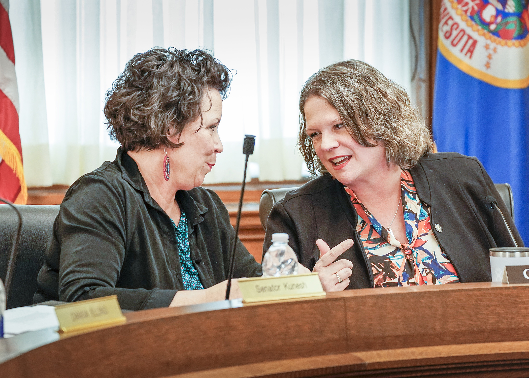 Rep. Cheryl Youakim, right, and Sen. Mary Kunesh confer during Friday’s meeting of the Education Finance and Policy Bill conference committee. (Photo by Andrew VonBank)